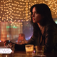 Jessica Jones having a drink.